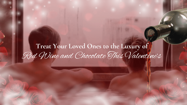Two people sit together in a bathtub, watching a romantic scene unfold. A bottle of red wine pours in the foreground. Text reads: "Celebrate Valentines in Japan by treating your loved ones to the luxury of red wine and chocolate this Valentine's Day.