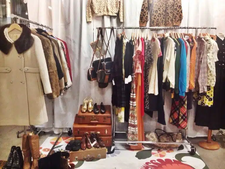 Clothing rails with various vintage coats, dresses, and jackets, plus handbags, shoes, and suitcases displayed in a boutique setting—perfect for finding your unique style or a special look for Valentines 2017.