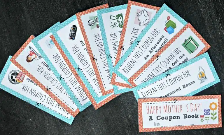 A set of colourful homemade Mother’s Day coupons fan out on a dark surface, each offering different favours like chores or treats—a thoughtful Mother’s Day gift. The cover reads, “Happy Mother’s Day! A Coupon Book.”.