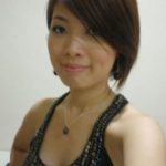 A woman in a black dress posing for a picture at an onsen spa.