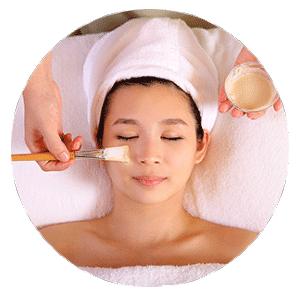 A woman receiving a facial treatment at a spa in Singapore.
