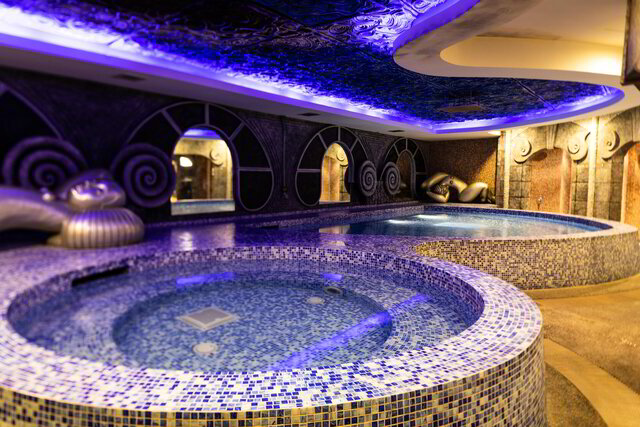 A luxurious indoor spa in Singapore features round, mosaic-tiled hot tubs under a ceiling adorned with purple lighting and decorative elements, offering an unparalleled experience alongside exquisite massages in Singapore.