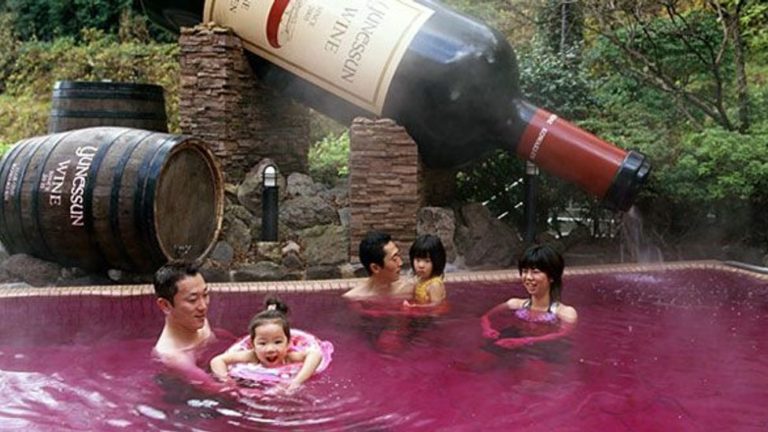 Family soaking in wine bath in Yunessun
