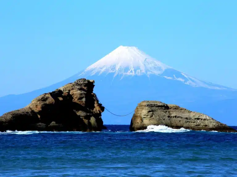 Mount Fuji seen across the boulders in Kumomi Coast