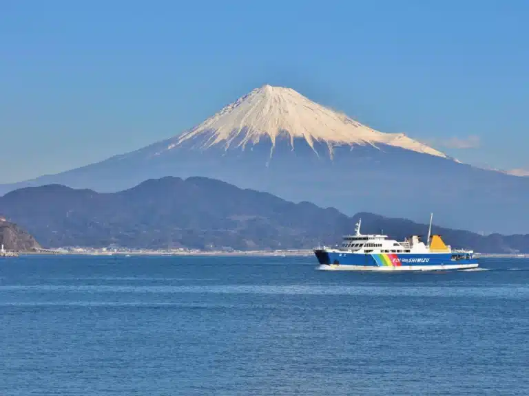 A ferry boat at suruga bay with Mount Fuji in the background