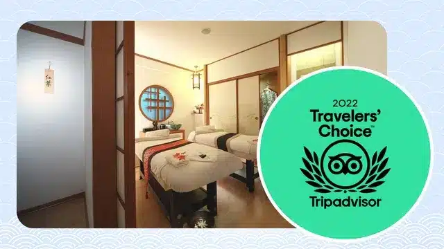 A spa room with three massage beds, soft lighting, Japanese décor, and Small Face Correction treatments, next to a green 2022 Tripadvisor Travellers’ Choice award badge.