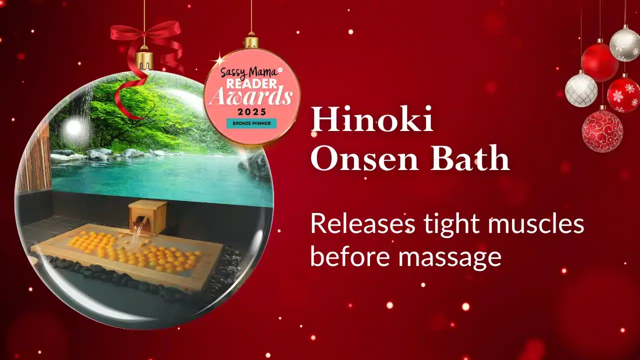 A holiday-themed graphic featuring a Hinoki Onsen bath, perfect as a Christmas gift card idea, with text stating it relieves tight muscles before massage and a "Sassy Mama Reader Awards 2023" badge.