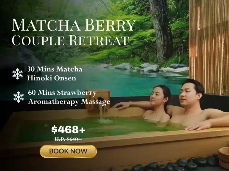 A couple relax in a wooden hot tub beside a pool in a lush outdoor setting. Treat yourselves to a £468 Matcha Berry Christmas spa retreat for couples, complete with onsen and massage treatments.