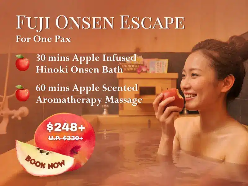 Smiling woman in a wooden bath holds a Fuji apple. Text promotes the Fuji Onsen Escape spa package with an apple-infused bath, aromatherapy massage, and special spa offers at a discounted price.